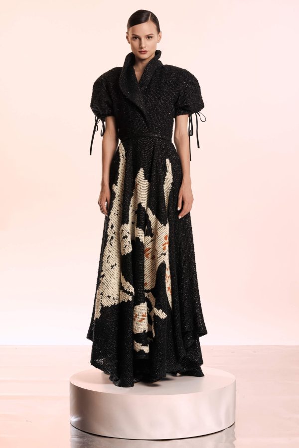 This gown is made from black boucle fabric and it has a hand embroidered lily. The puffy sleeves and the lapels gives a sophisticated air. Has a thin belt to accentuate the waist.