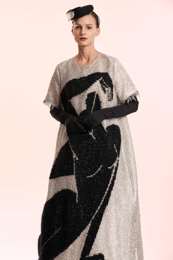 The Silver Maxi Dress is definetly a show-stopper. Made from a special silver fabric and white viscose lining, this dress falls in a perfect A-shape. It has a silhouette embroidered with black thread all over the front. Its texture perfectly complements the shimmer of the dress.