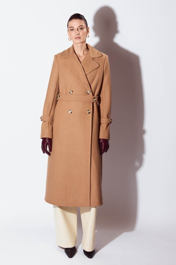 It’s a standard fit straight slightly A-lined lined coat. It's outlined by tonal chain stitches. Set-in long sleeve features two seams and a stitched pin tuck at the front seam.