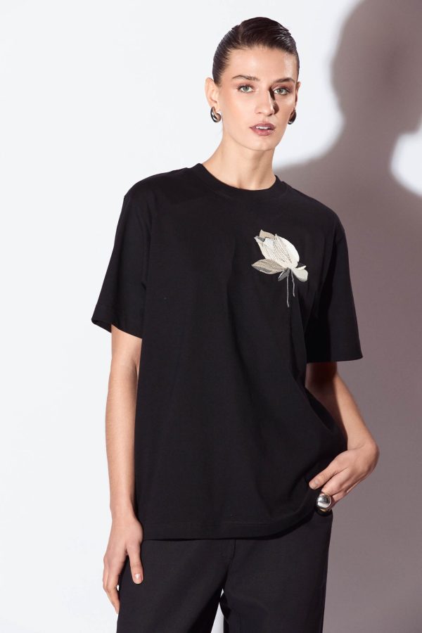 It's hard to overstate the versatility of a black T-shirt. This one is crafted from premium heavyweight organic-cotton and it's bautifully embroidered with a lotus flower in neutral colors. It has a slightly-loose fit.