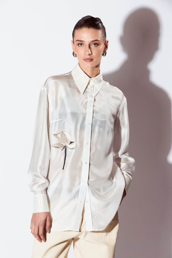 This shirt is a versatile choice for your wardrobe. It is made of silk and has a relaxed look, complementing the silhouette. The lightly see throw texture and the lotus flower embroidery adds an extra touch of refinement.