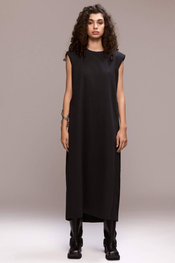 Black sleeveless, loose-fit maxi dress designed to flow on the body, with beautiful back pleats and structured padded shoulders. The dress includes a removable self-tie belt to cinch the waist and side pockets.