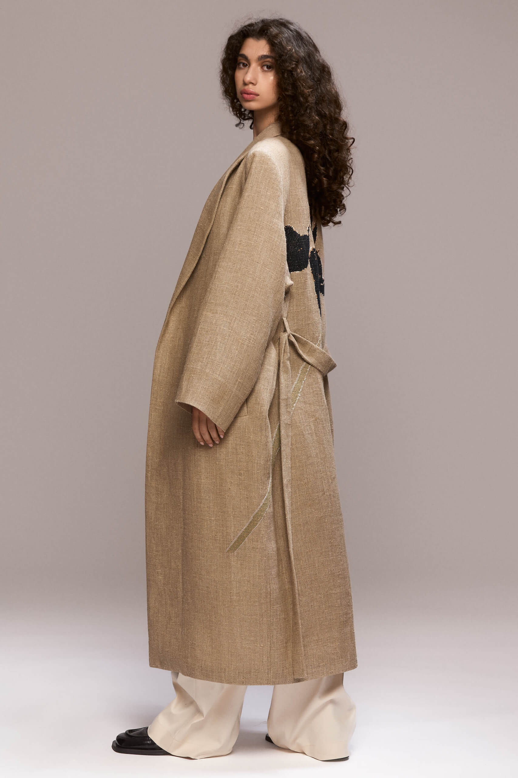 Crafted from hemp, this coat offers a lightweight yet sophisticated layer. It features a hand embroided lily on the back and and it has a unique and relaxed silhouette.