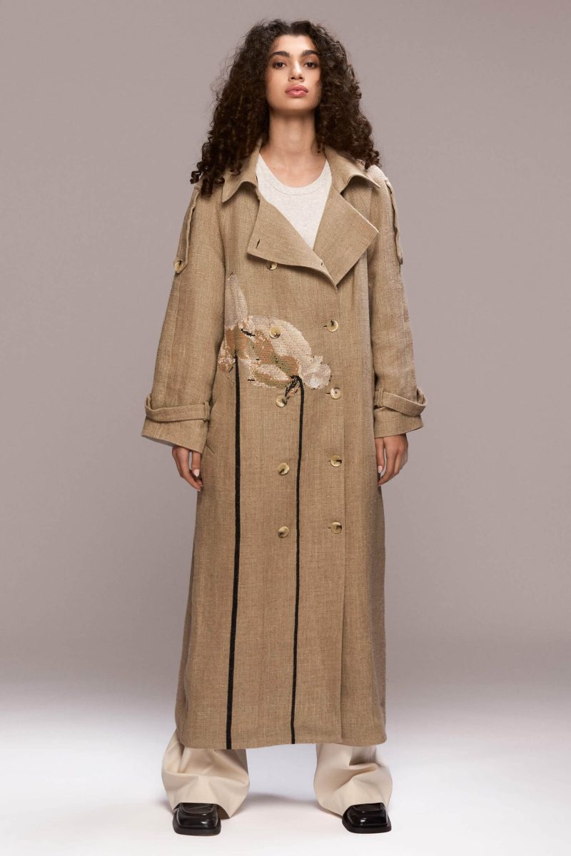 This long beige coat is made of 100% and it features a handmade lotus flowers. It also has a detachable belt.