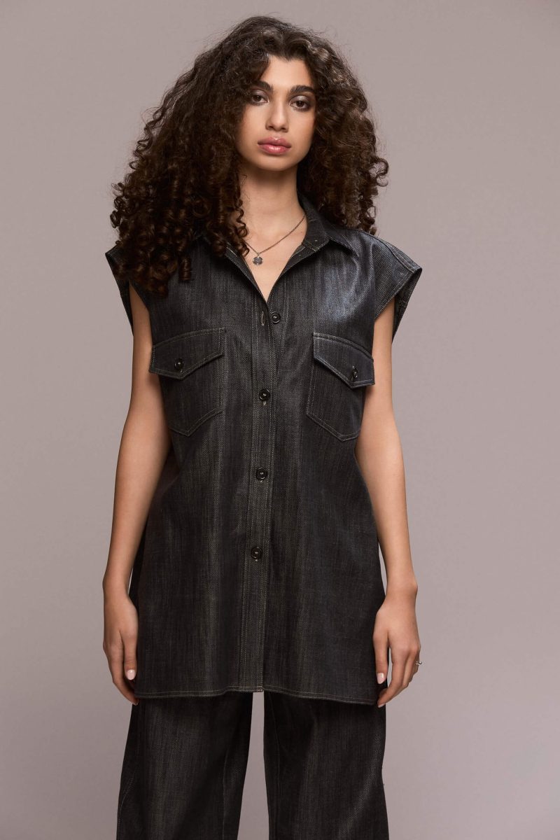 A sleveless, oversized button-down shirt featuring a collared neckline and dual chest pockets, this piece gives a distinctly modern and eye-catching appearance. Wear it with our matching wide leg trousers for a full statement look.