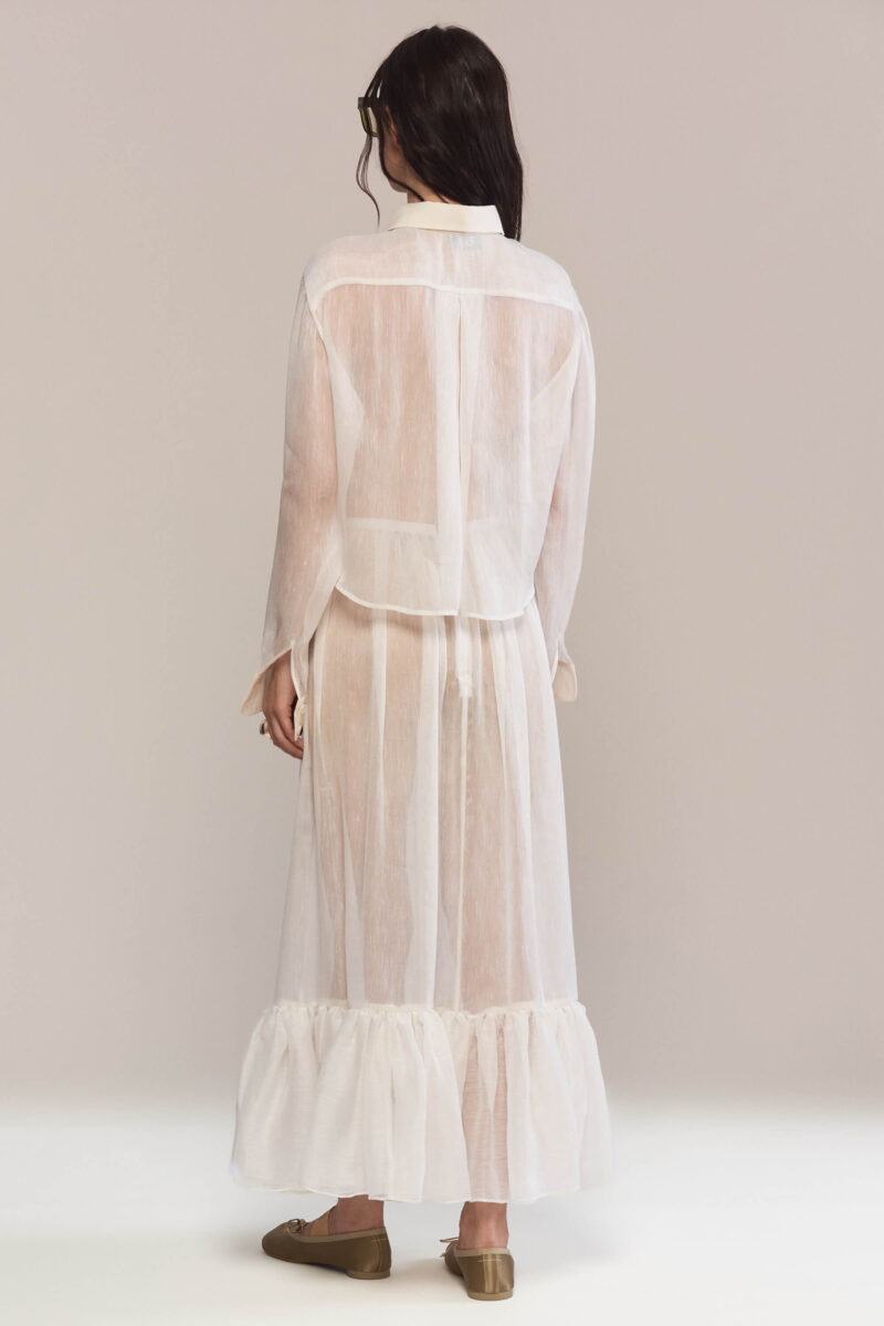 Crafted from pure silk, with a classic button-down, this elegant long sleeved shirt with a relaxed fit has a beautiful black lace hearts embroidery. Wear it with our matching maxi white silk skirt for a casual yet sophisticated look.