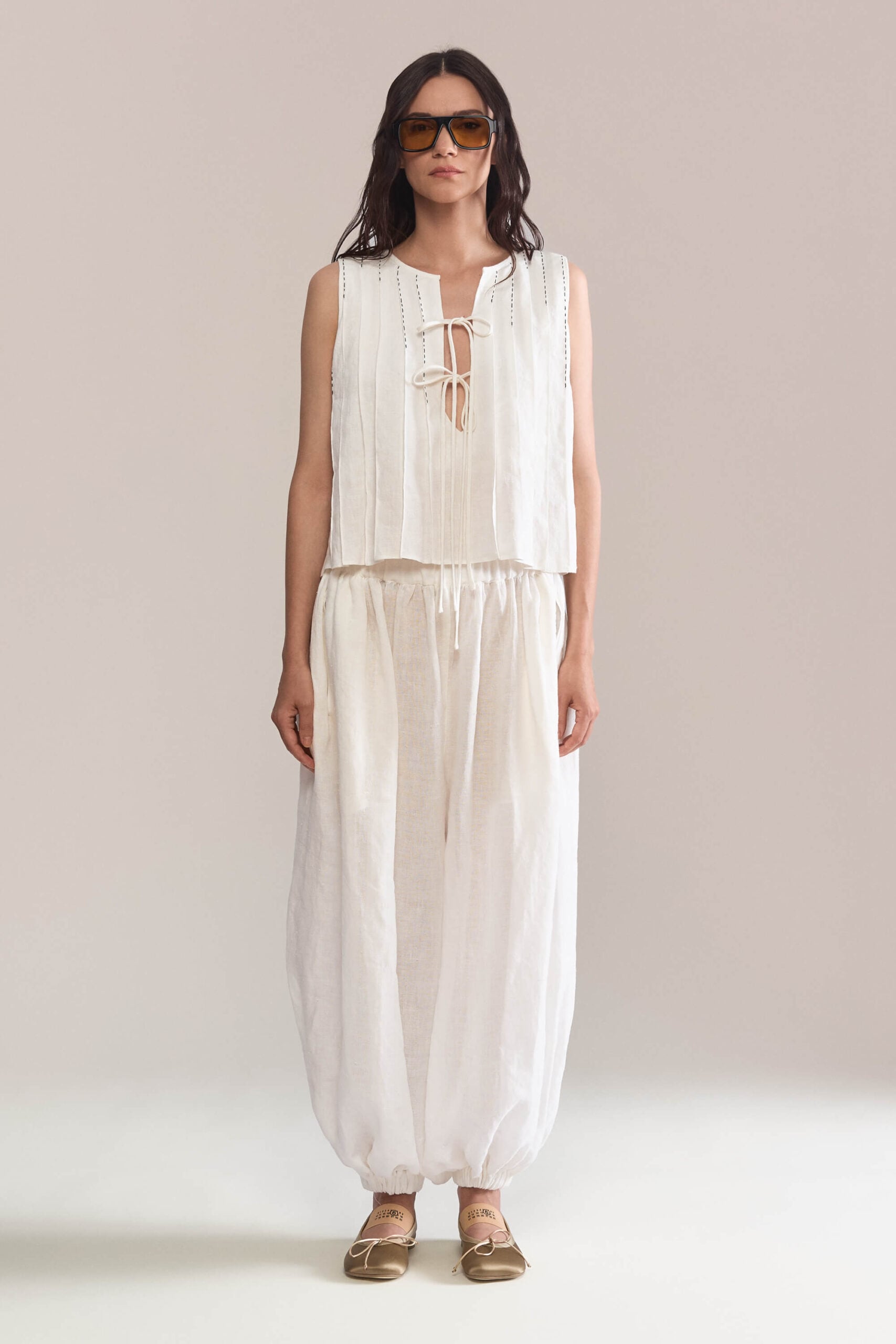 These full length balloon-style pants features drapes and an elastic waist. Made of linen, they are comfortable to wear and ideal for warm weather.