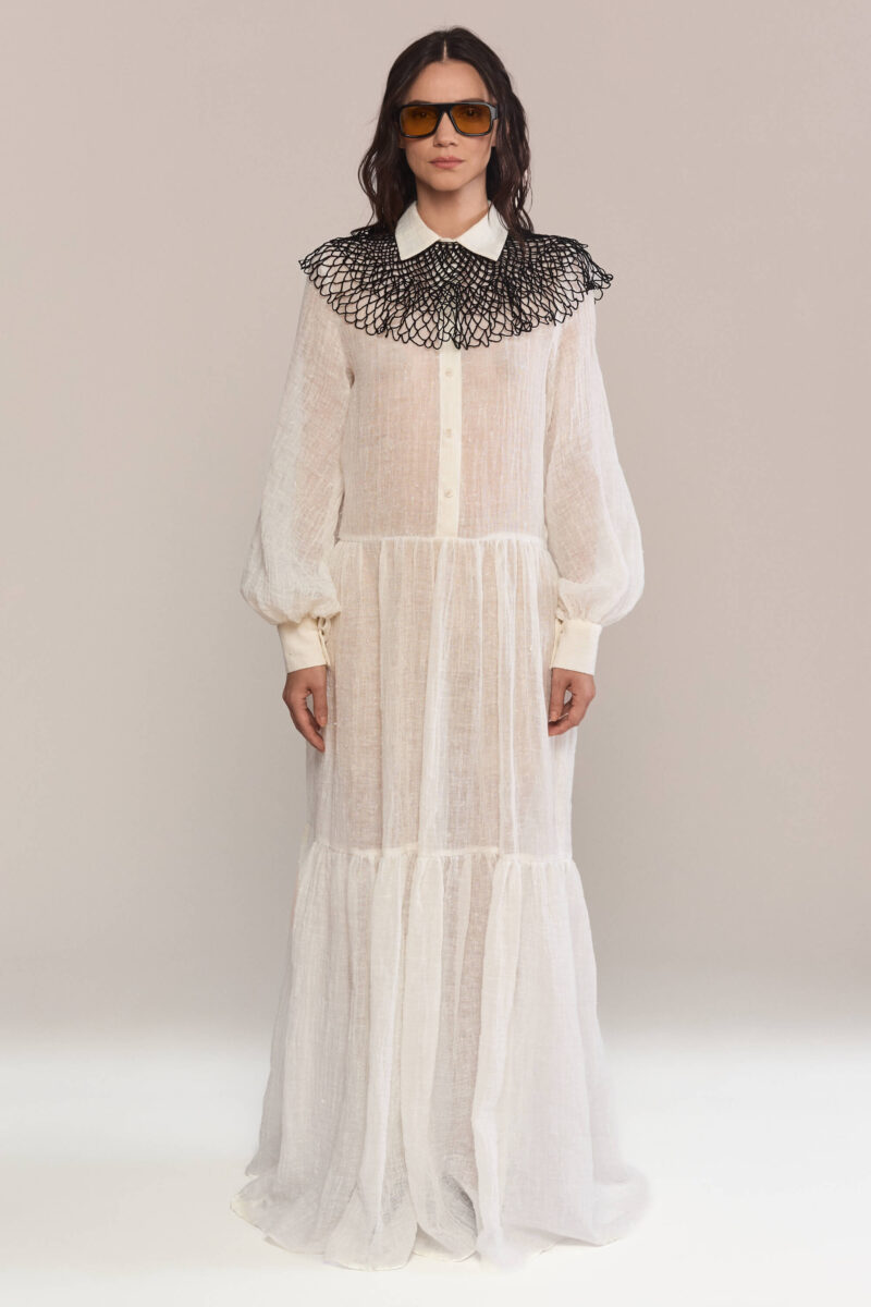 Exude timeless charm in this semi-sheer maxi long dress, featuring a delicate handmade collar. Crafted from lightweight linen, it flows into a breezy silhouette for effortless elegance and a captivating presence.