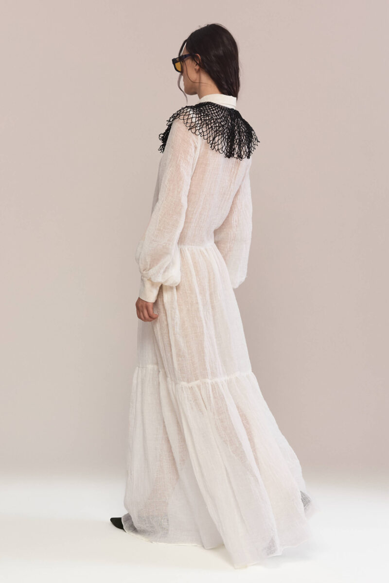 Exude timeless charm in this semi-sheer maxi long dress, featuring a delicate handmade collar. Crafted from lightweight linen, it flows into a breezy silhouette for effortless elegance and a captivating presence.