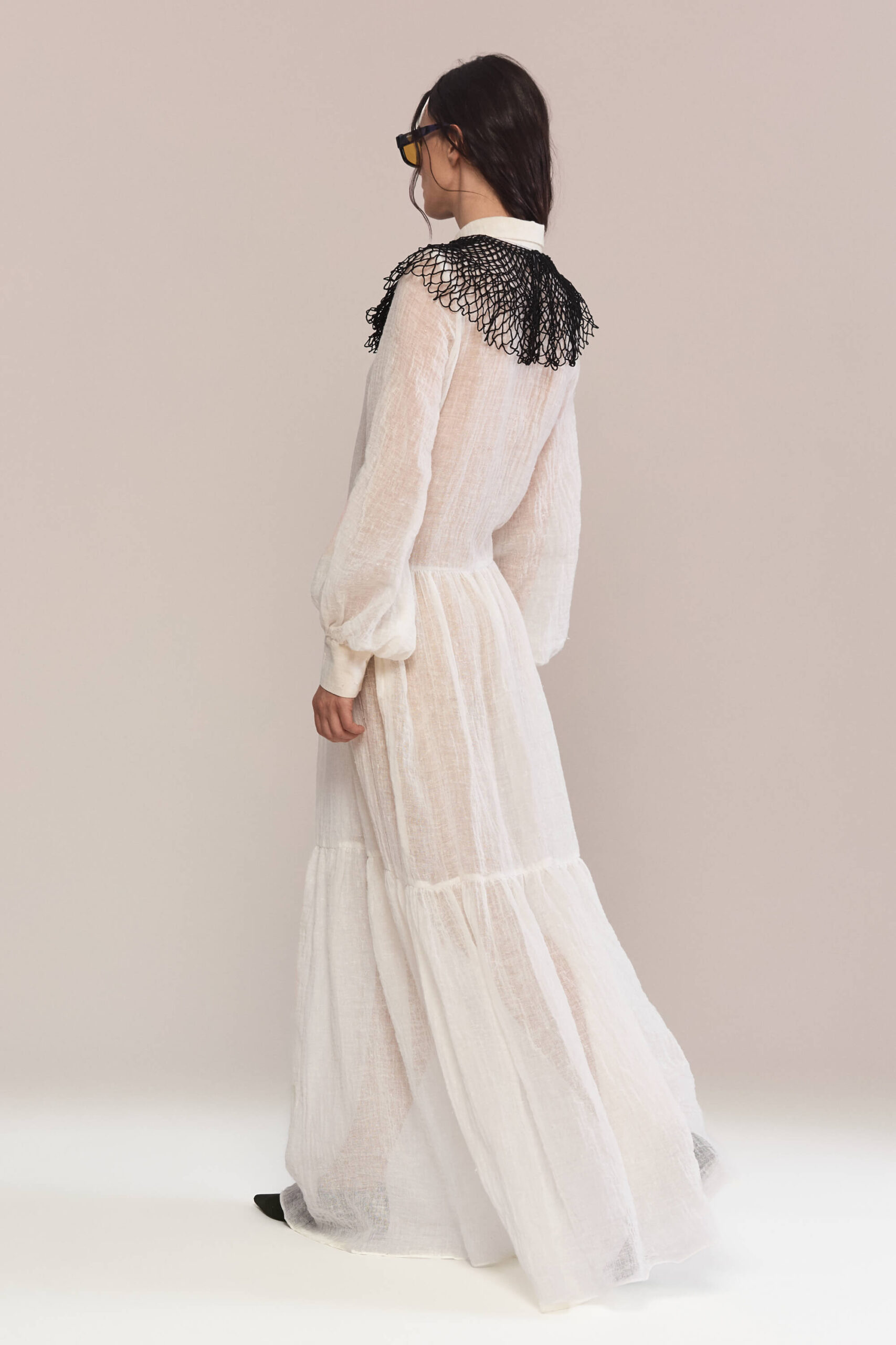 Exude timeless charm in this semi-sheer maxi long dress, featuring a delicate handmade collar. Crafted from lightweight linen, it flows into a breezy silhouette for effortless elegance and a captivating presence.