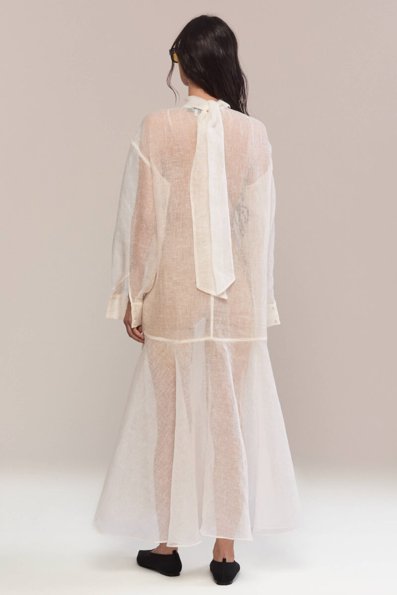 Refinement and comfort in one dress: the high neckline and loose fit combine with the handmade black floral embroidery, creating the perfect outfit for a chic daytime look or an elegant evening appearance.