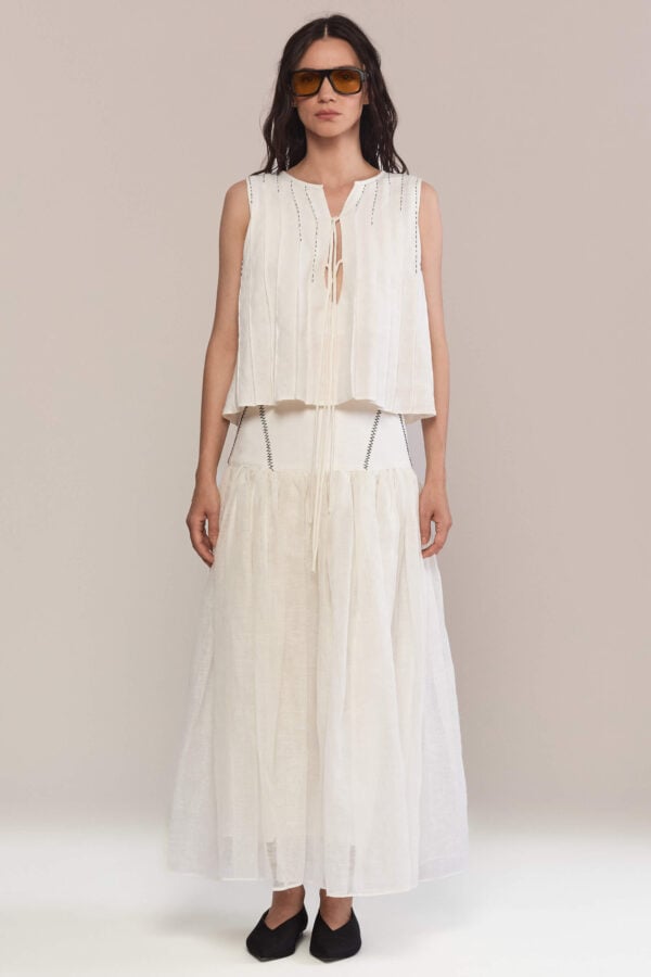 This maxi linen skirt features a gathered waistline for a relaxed and comfortable fit, embelished with hand stitches. Pair it with a matching top and simple black flats for a minimalist look.