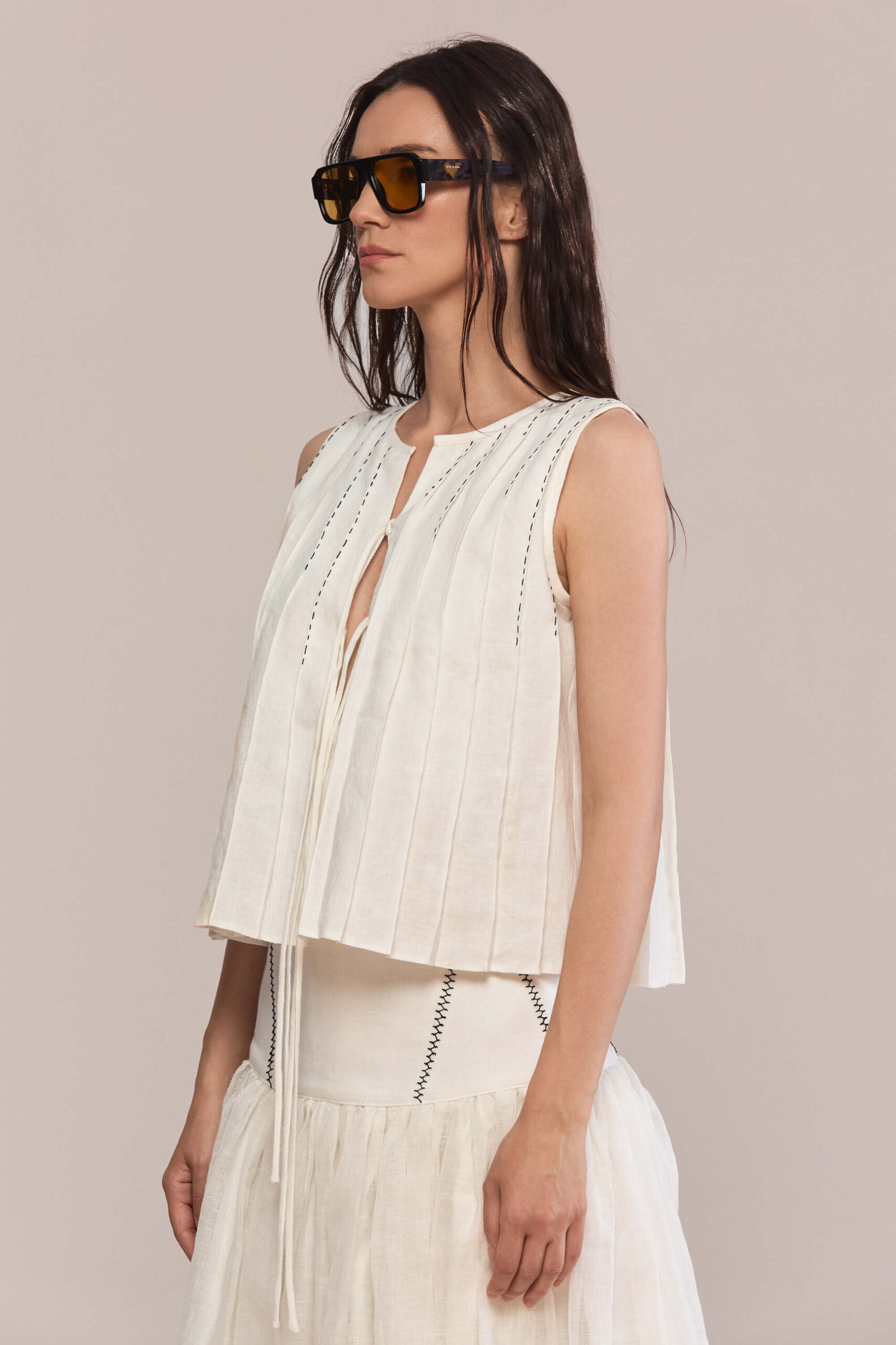 This maxi linen skirt features a gathered waistline for a relaxed and comfortable fit, embelished with hand stitches. Pair it with a matching top and simple black flats for a minimalist look.