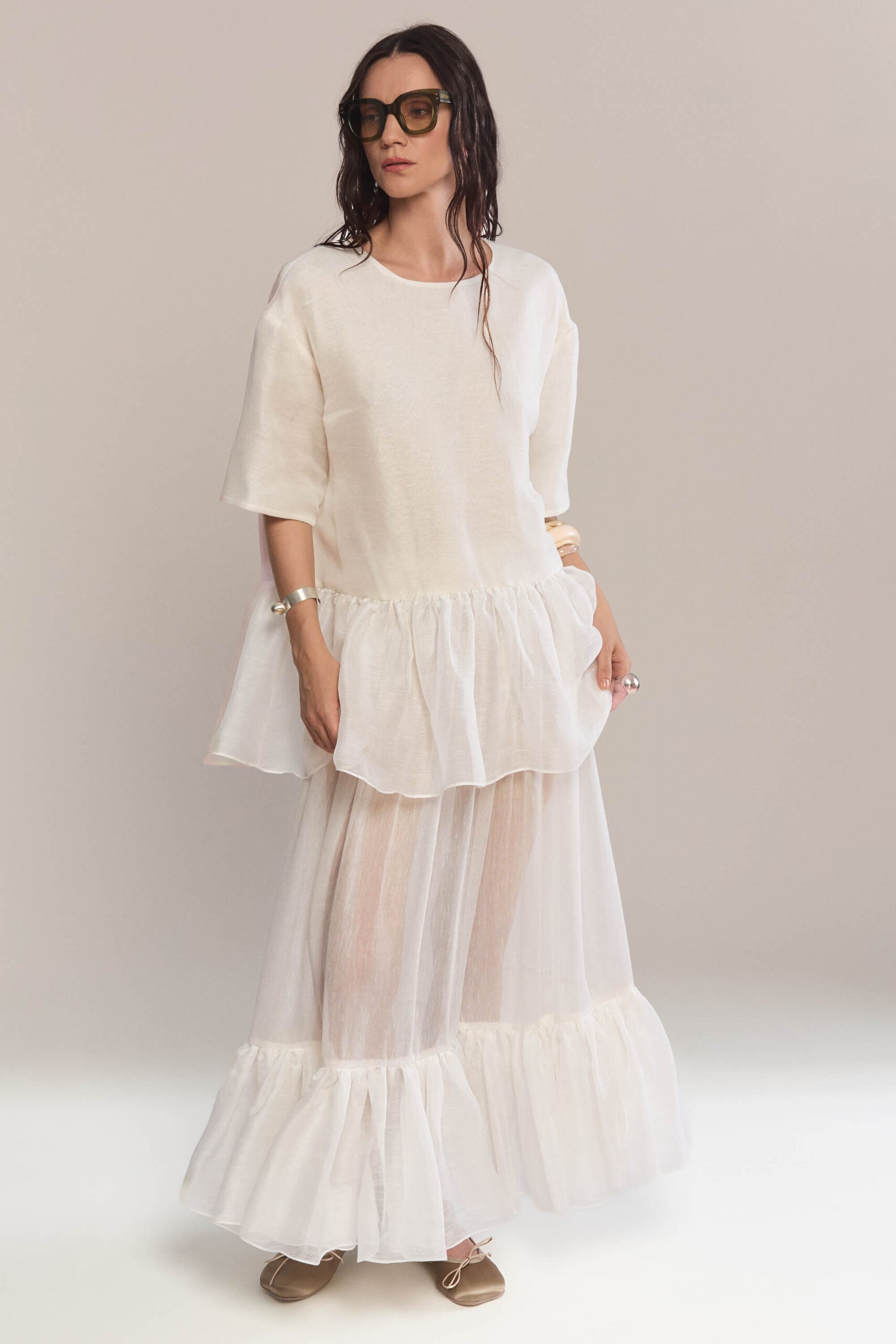 This maxi skirt combines the subtle sheen of silk with voluminous ruffles at the hem, offering a sophisticated and fluid look. Wear it with our matching frilled white top.